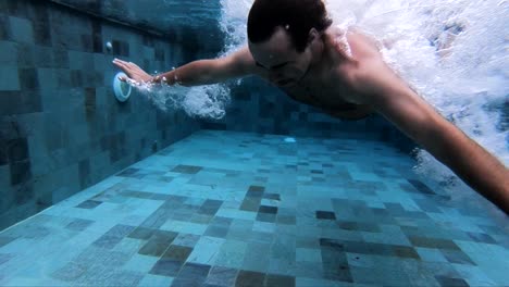 extreme slow motion underwater shot of a man doing a belly flop into the water