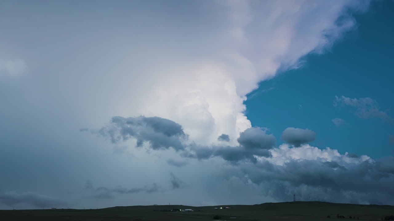 Stars And Towering Lightning Storm Cloud In Soft Twilight