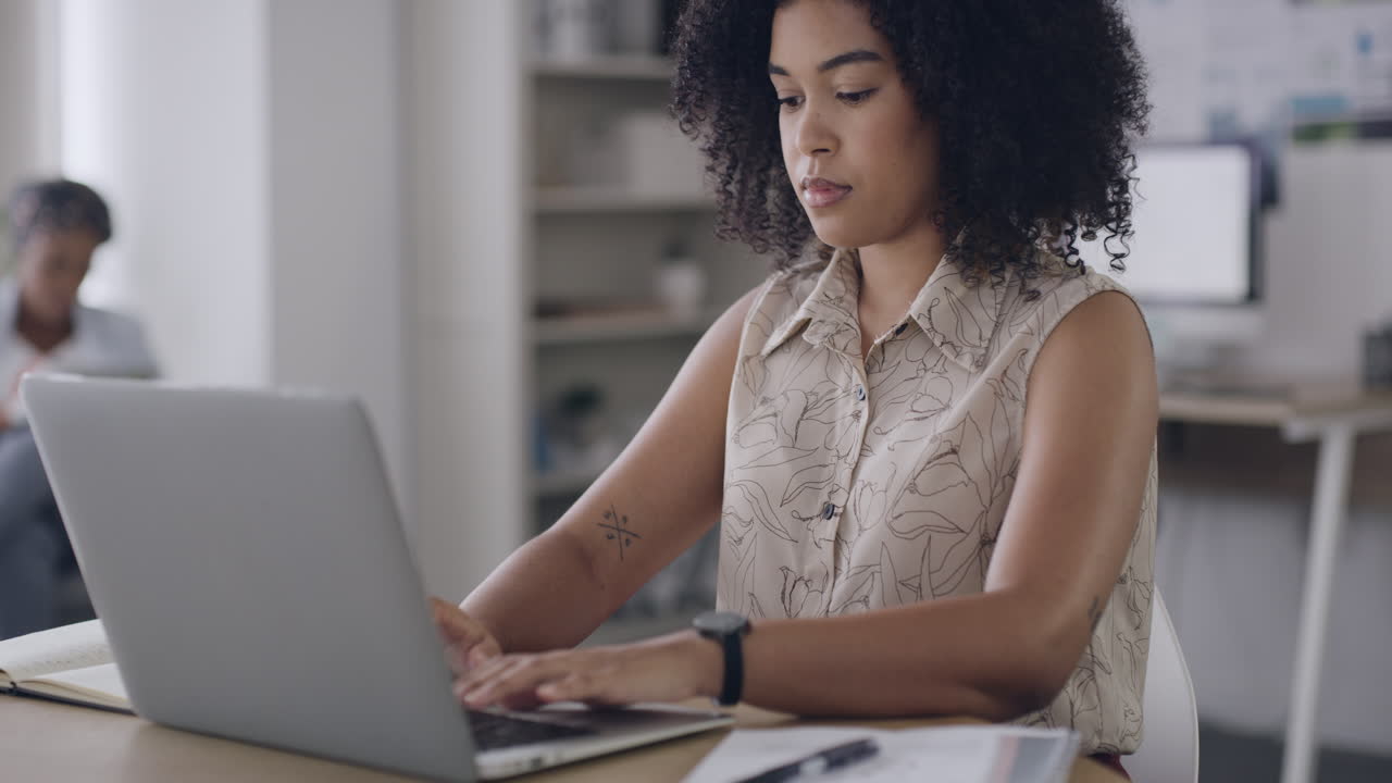 Young business woman typing on a laptop