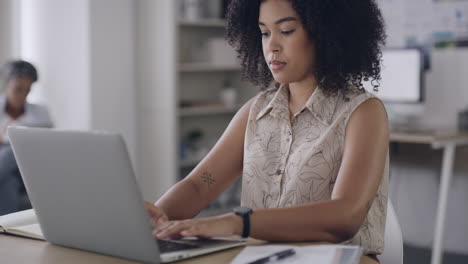 young business woman typing on a laptop