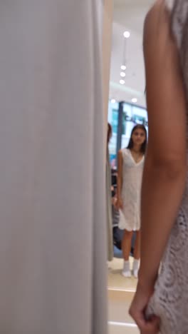 woman trying on a dress in a fitting room