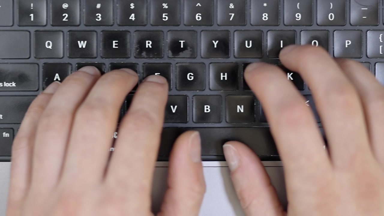 Top down shot of laptop keyboard with coffee for work or study break