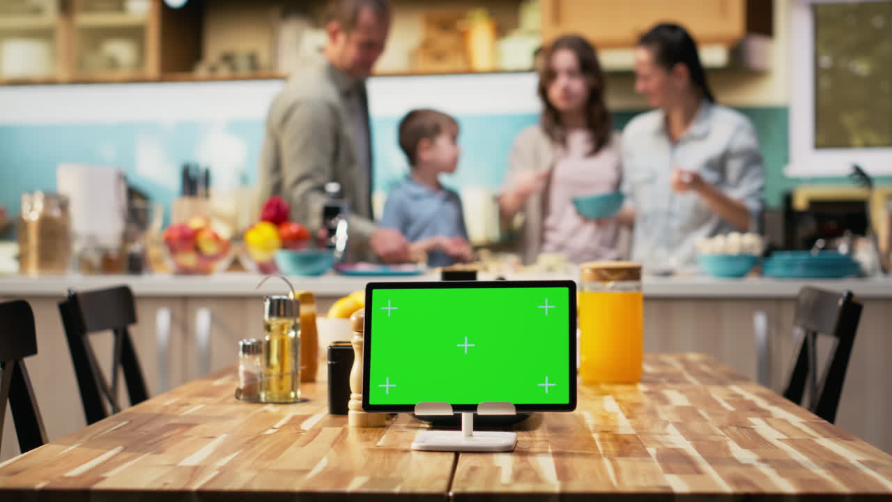 Horizontal chroma key on tablet near cute family preparing homemade meal