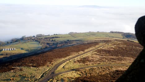 Fog-clouds-passing-across-countryside-moorland-valley-viewpoint-from-stone-tower-battlement-wall-dolly-right