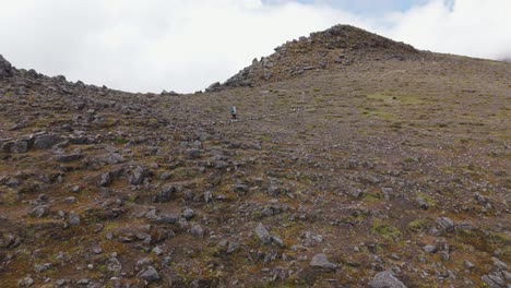 adventurers hiking along a rugged mountain trail with rocky ground