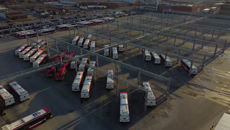 ttc public transit buses at large operations, maintenance and storage facility as bus exits garage; aerial