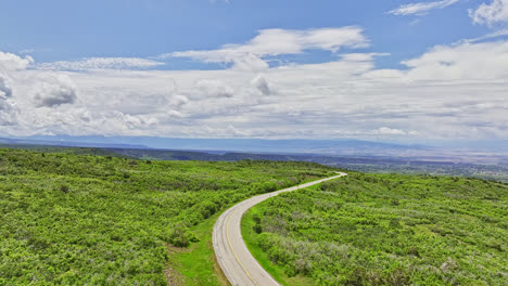 Drone-flyover-of-winding-road-on-the-Grand-Mesa-in-Grand-Mesa,-Colorado