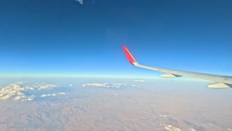 scenic flight over mountainous terrain and clouds