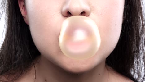 brunette girl blowing a bubble of yellow gum brunette blowing a bubble of gum yellow red lips face sexy