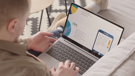 man with prosthetic leg looking at marketing statistics on laptop