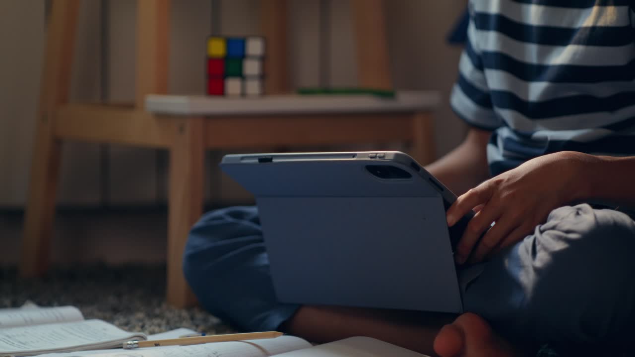 Child Studying with a Tablet at Home
