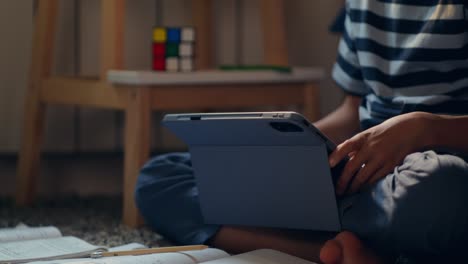 child studying with a tablet at home