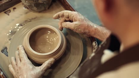 top view senior man making a cup during pottery art