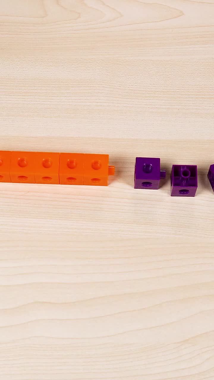 Hands assembling colorful cubes on a table