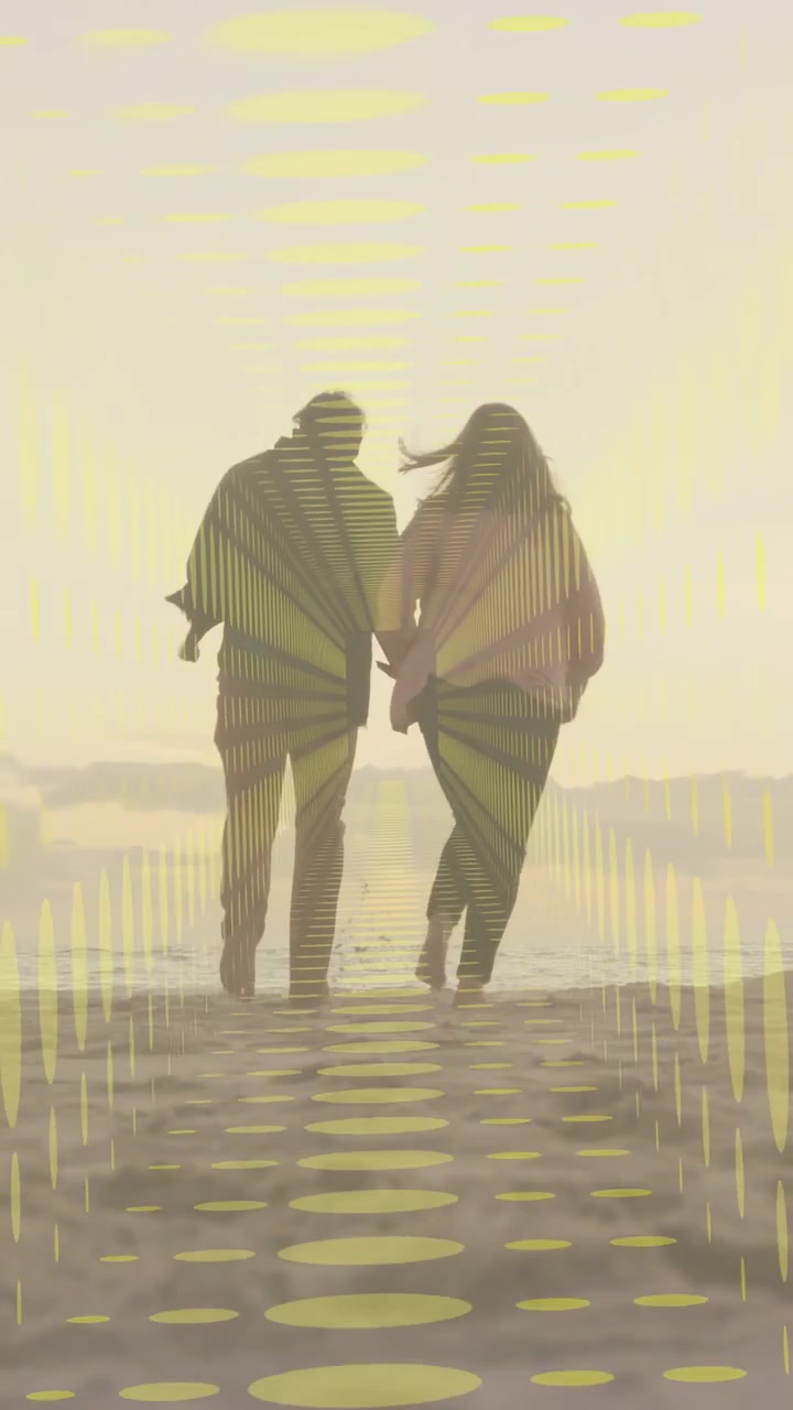 Vertical video: Sunset urging couple walking on sand yellow stripes sliding over couple for travel