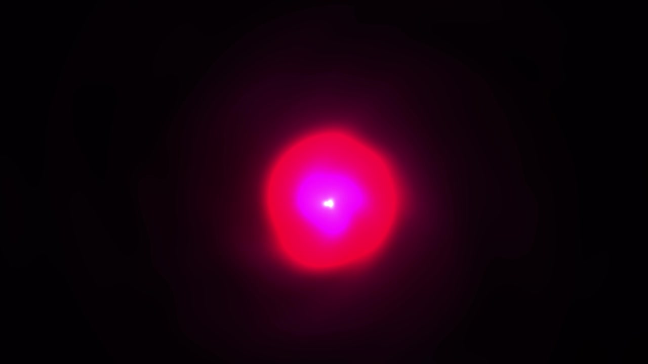 Pulserande röd och magenta ljusglob på svart bakgrund