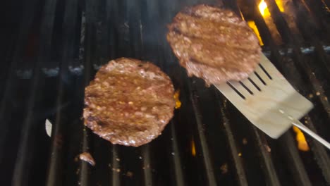 hamburgers being cooked on the grill