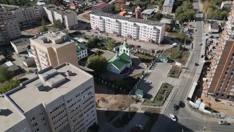 aerial view of a city with apartment buildings and a church