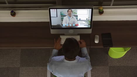 Overhead-view-of-man-having-a-video-conference-
