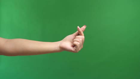 A Hand Signs Gesture To Be Little Heart From Tip Of Thumb And Index Finger On Green Screen Background