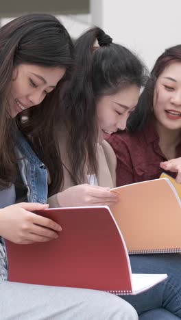 three asian girl students talking at break time sitting on campus