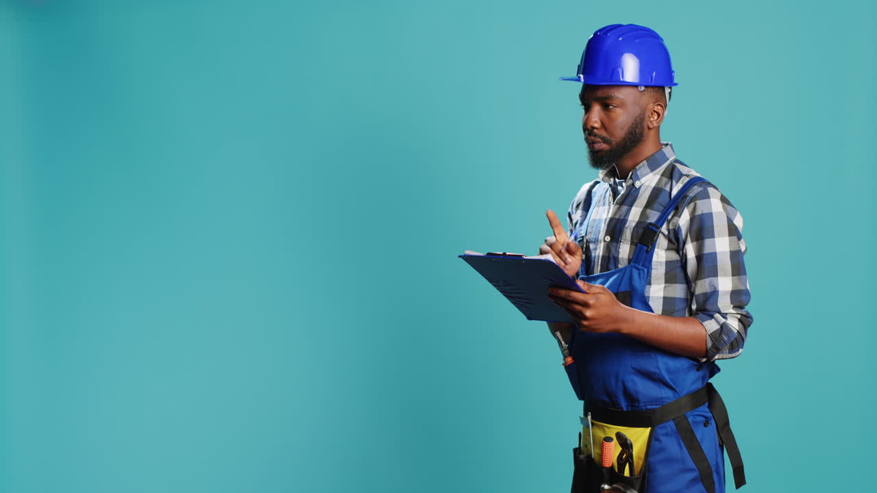 Confident builder making calculations on papers