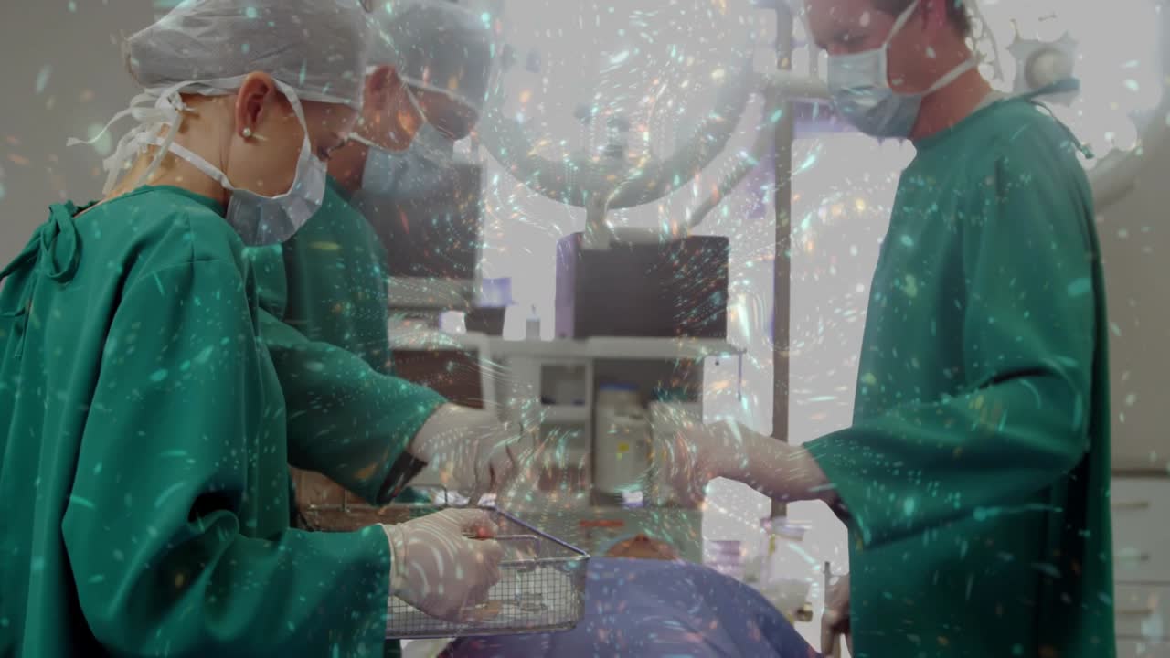 OR team sorting tools on blue drape for surgery, surgeon rotating basket, assistant handing clamp
