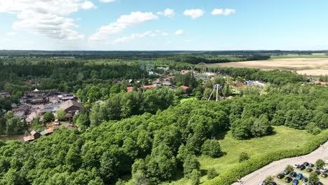 djurs sommarland amusement park in jutland djursland denmark - descending aerial from full park overview to parking lot outside - 60fps