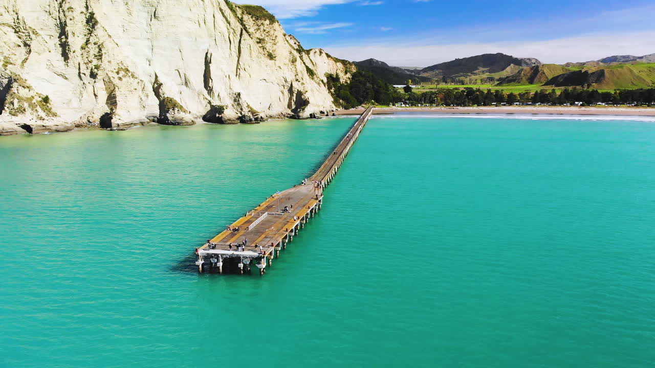 Long wharf beside white cliff - aerial