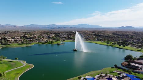 Fountain-Hills-water-flume-casts-dark-arched-shadow-on-lake-in-middle-of-community-at-midday,-Arizona