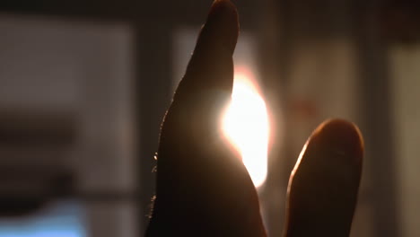 look at the sunset through the silhouette hand