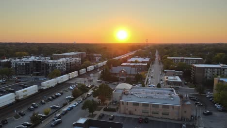 sunset aerial view of suburban city with freight train