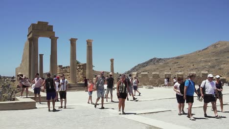 tourists exploring ancient ruins in greece