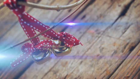 composition of light over christmas decorations with bells