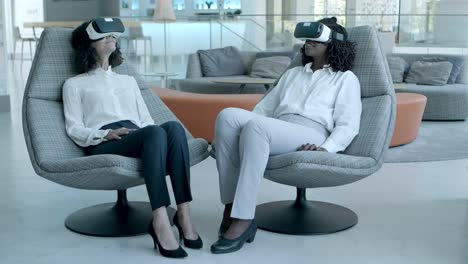 cheerful businesswomen in vr headsets