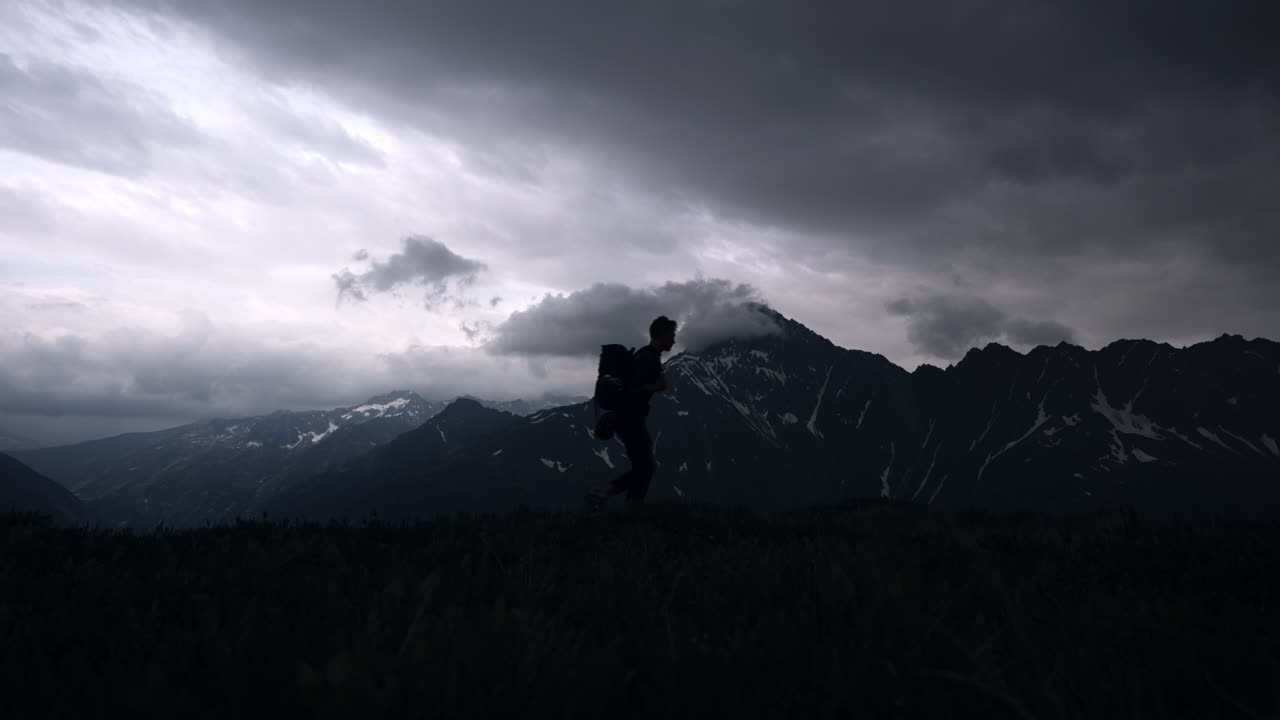 Hiker in the Mountains During a Storm