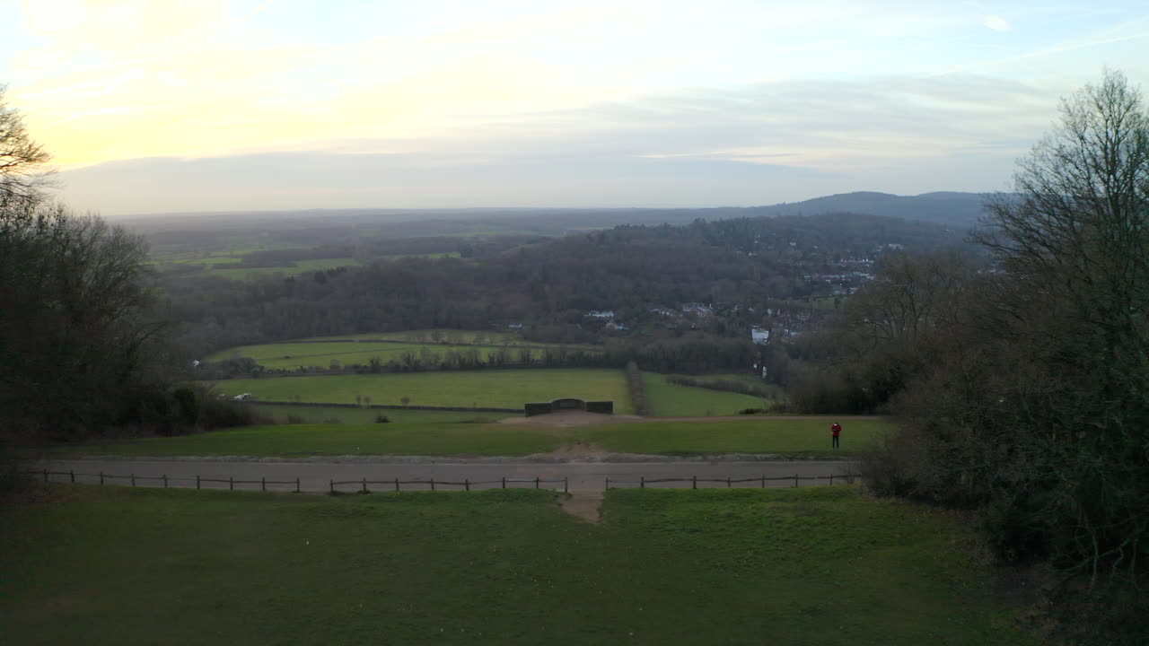 An aerial shot flying over Box Hill viewpoint in the countryside of England in Surrey Hills near Dorking in the morning