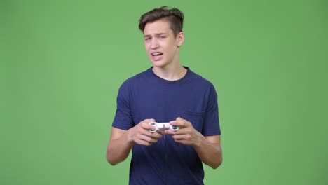 young handsome teenage boy playing games