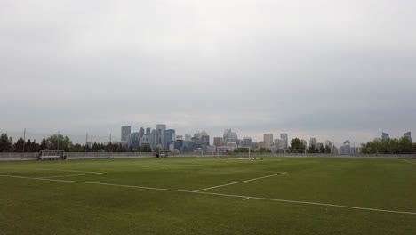 soccer field with city skyline pan calgary alberta canada