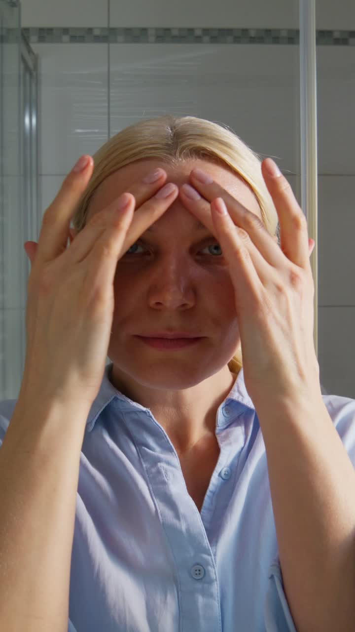 Woman Checking Her Appearance in Bathroom