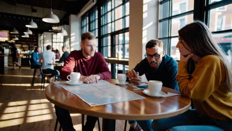 friends planning trip at coffee shop
