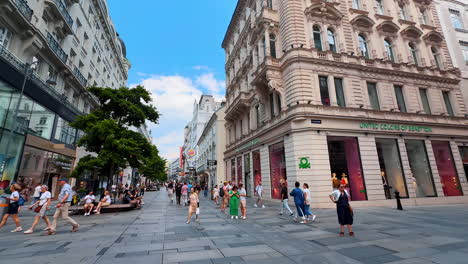 vienna, austria - june 9, 2025: central part of modern vienna, austria. lots of people walk by the street with shops in the historical buildings