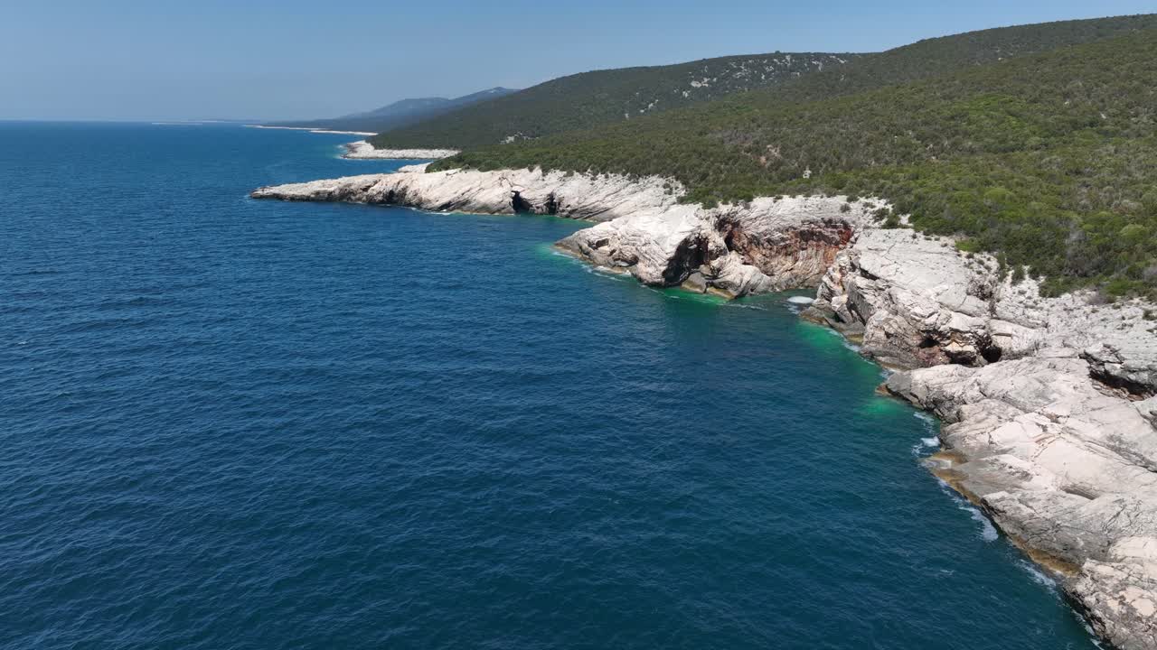 Aerial view of beautiful coastline with blue sea and rocky cliffs