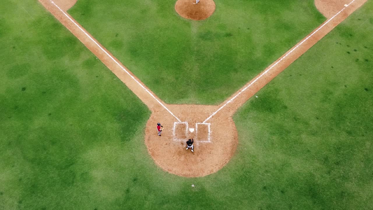 San pedro de macoris, DR - March 12, 2021 - aerial view drone young people playing baseball at stadium in san pedro, training session