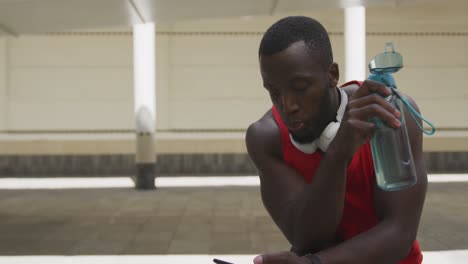 Man training in an urban setting taking a break