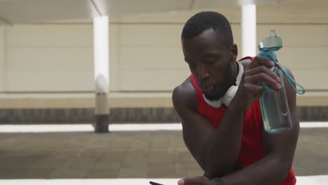 man training in an urban setting taking a break