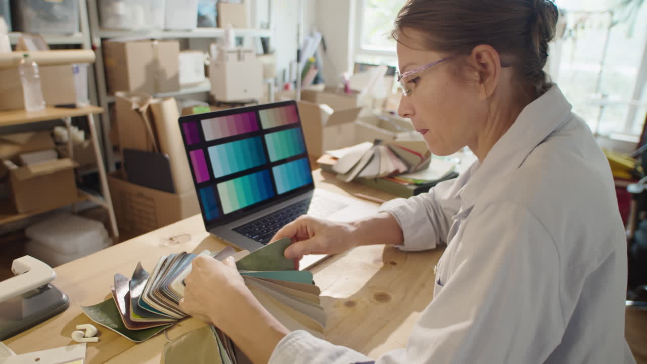 Female Designer Choosing Color and Material in Workshop