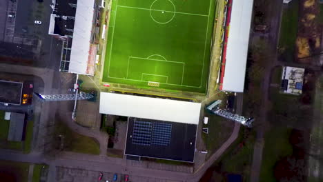 Top-down-aerial-pass-over-soccer-players-playing-football-in-stadium