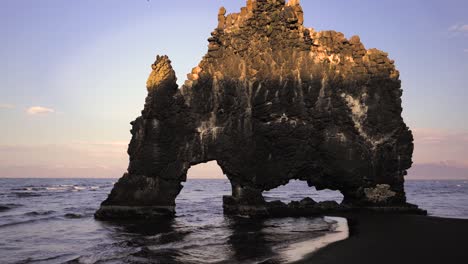 different shots, including slowmo, roll, dolly in all types of light showing hvitserkur rock in iceland