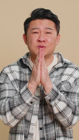 asian man show a little bit gesture begging help need some more please give me measuring small size